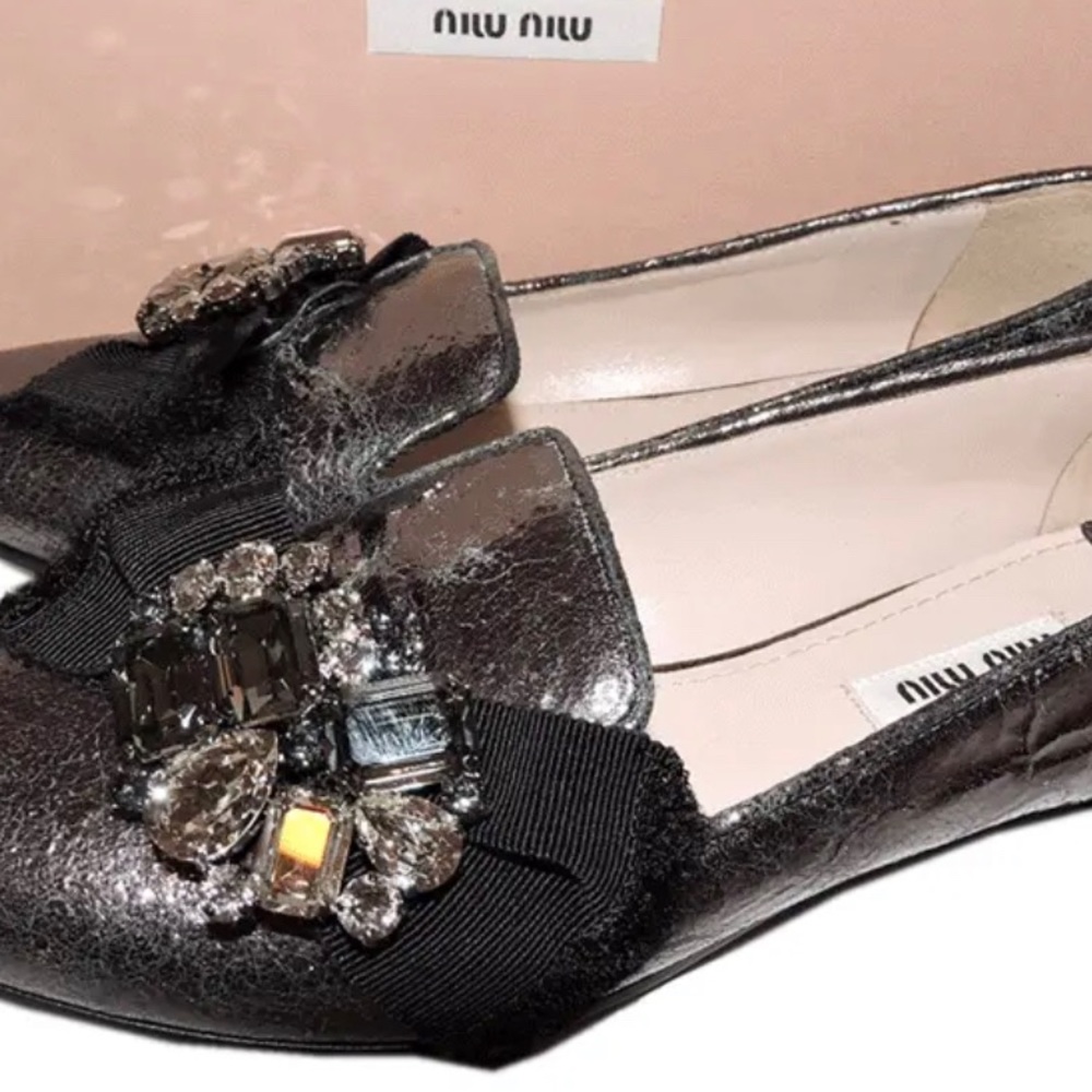 MIU MIU cracked leather crystal embellished loafers.